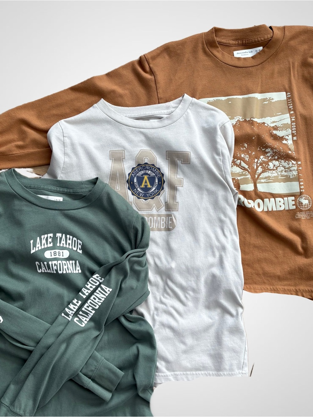 abercrombie kids long sleeve tees in white, green, and brown